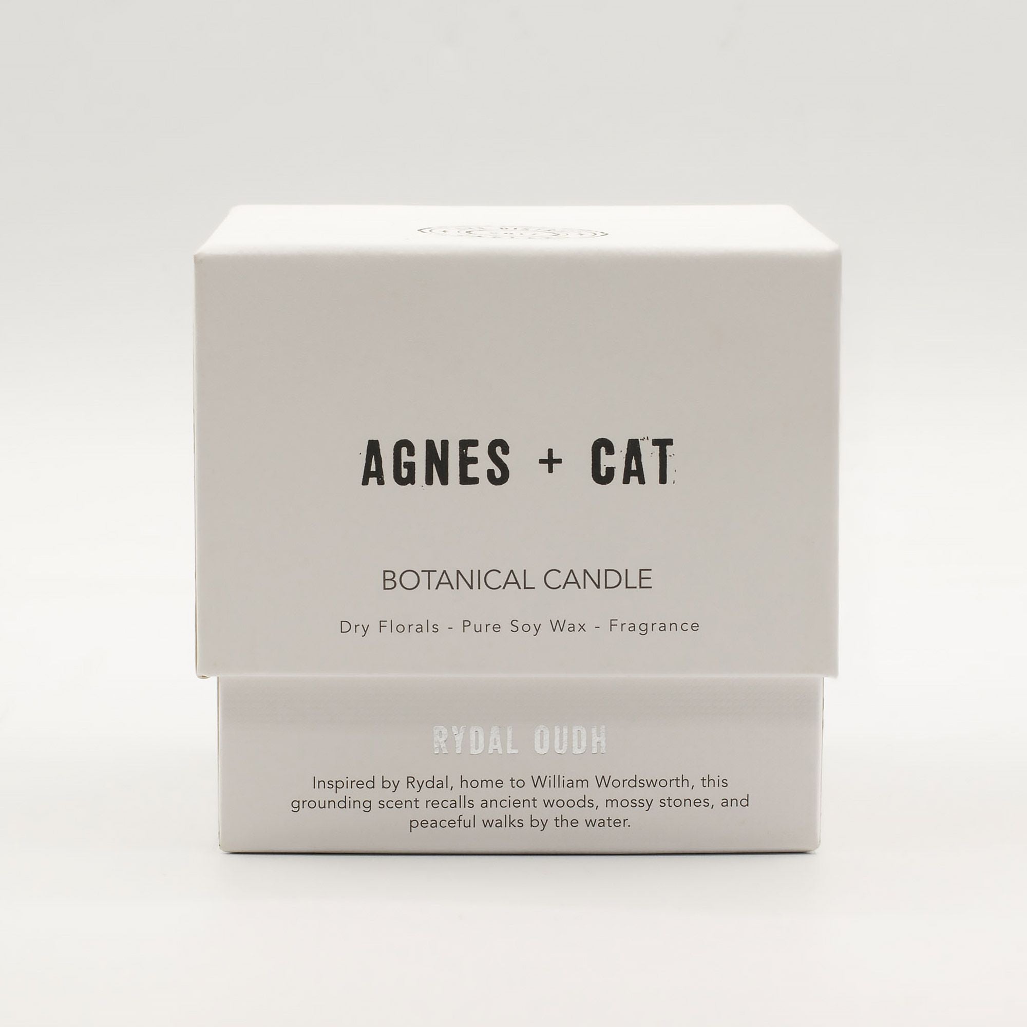 Box of Agnes + Cat botanical candle on a white background