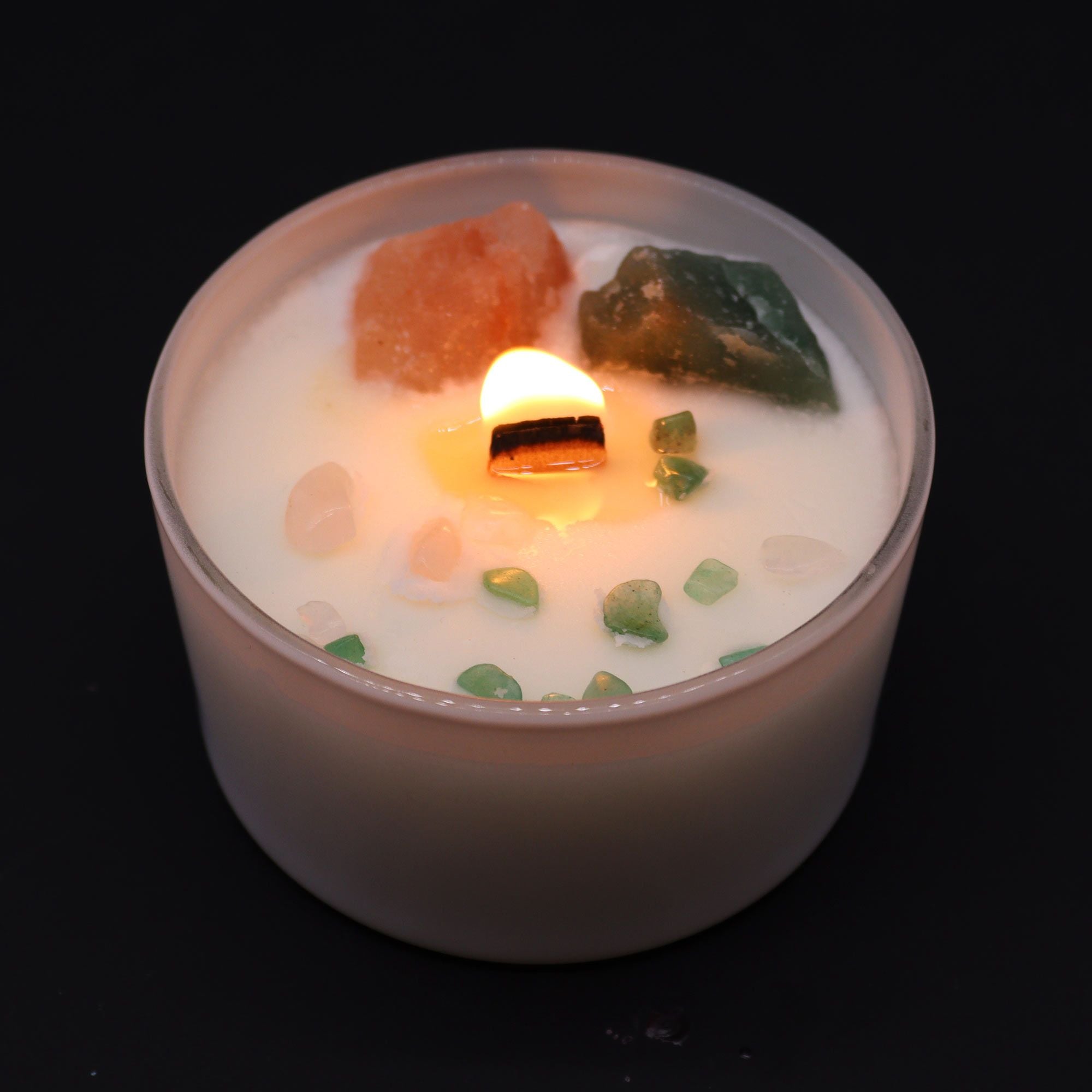 Candle with decorative elements on a black background