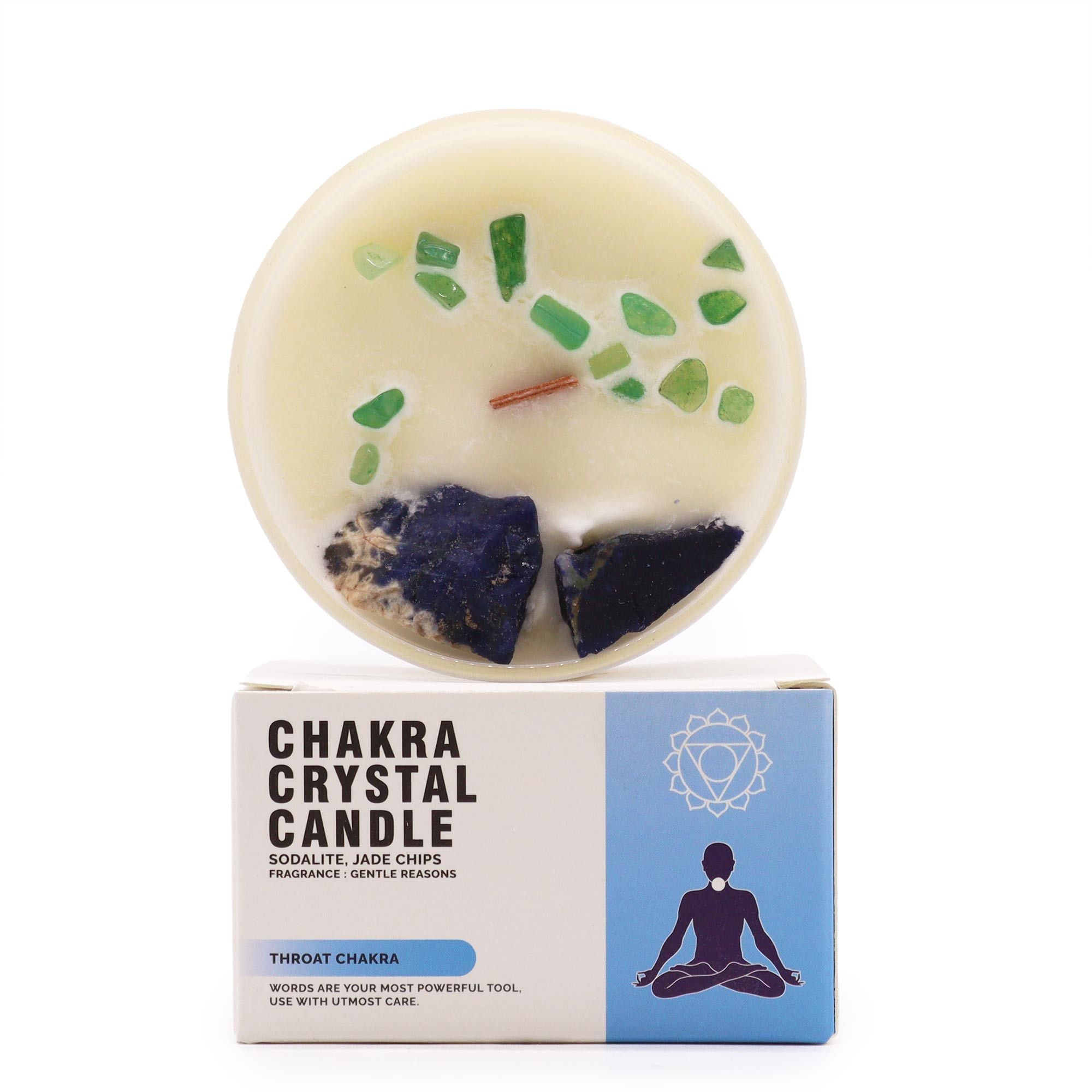 Chakra crystal candle with visible stones on a white background