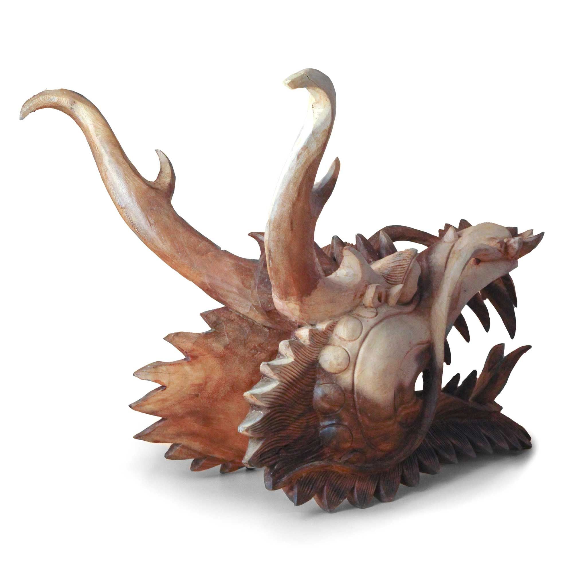 Wooden dragon head sculpture on a white background