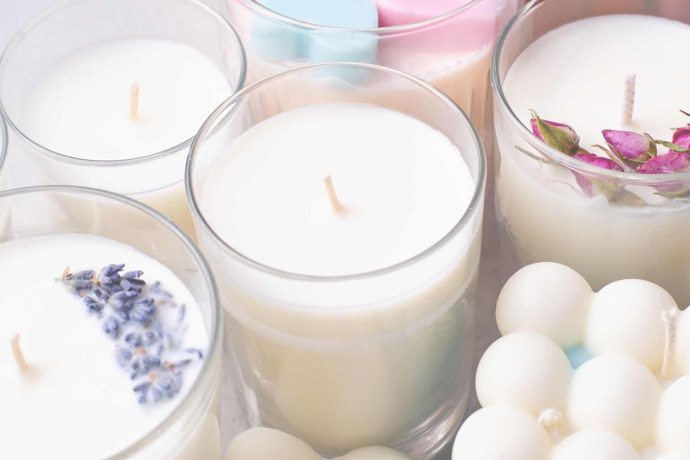 Candles in glass holders with decorative elements on a white background