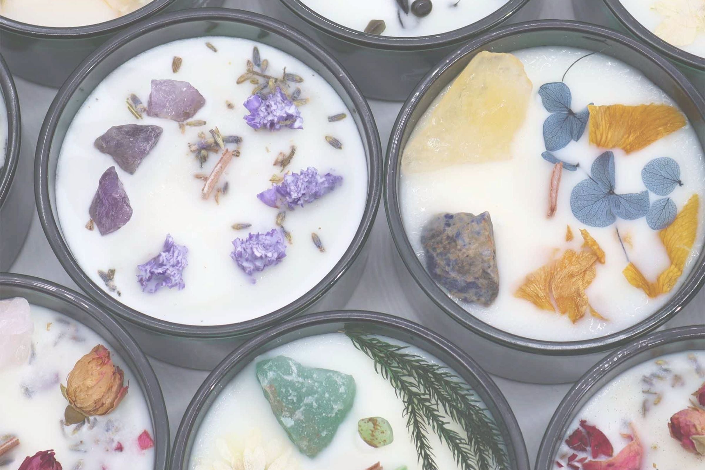 Soy wax candles with natural elements in dark-coloured jars