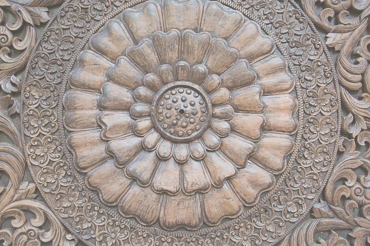 Close-up of intricate floral carvings on a wooden surface