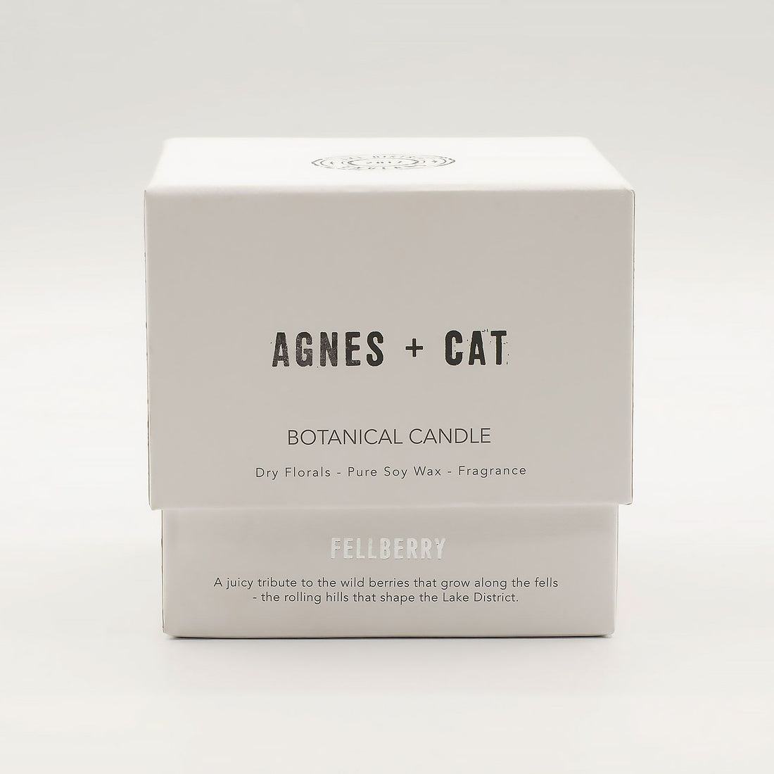 Box of Agnes + Cat botanical candle on a white background