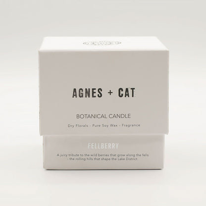 Box of Agnes + Cat botanical candle on a white background