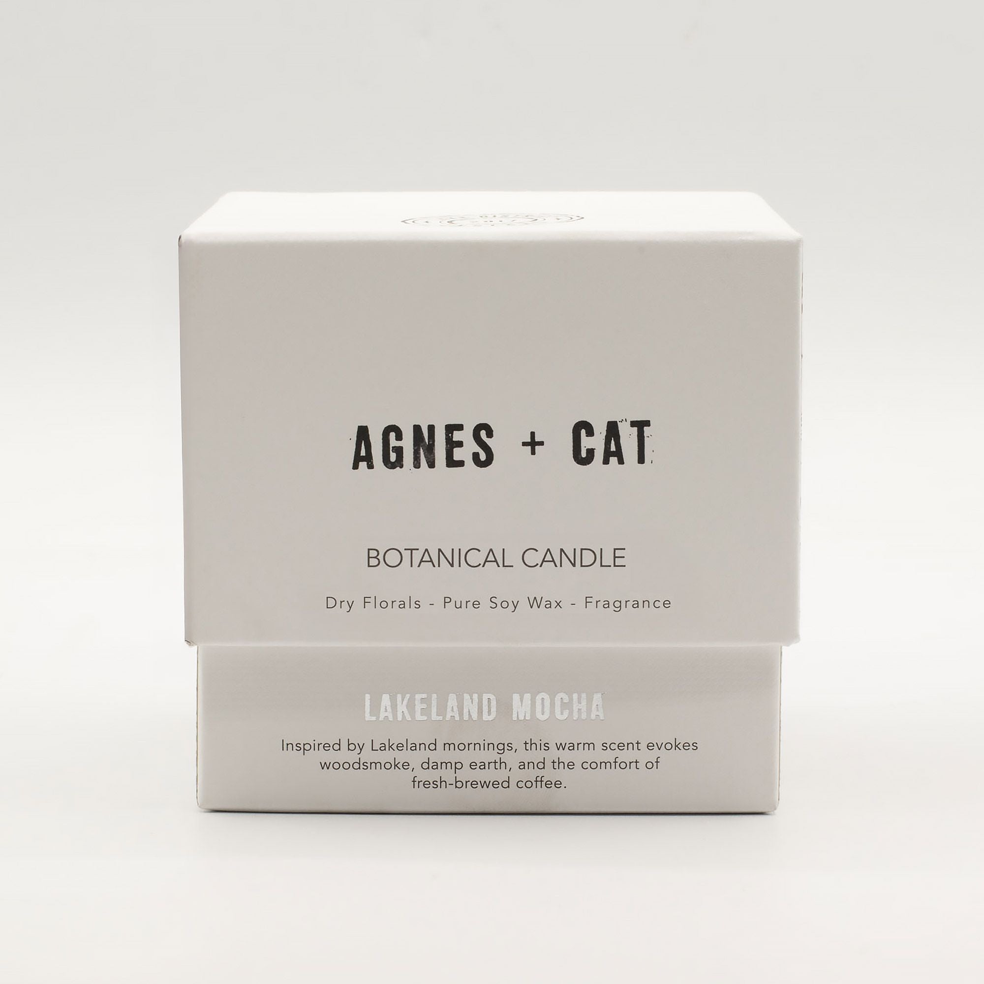 Agnes + Cat botanical candle packaging on a white background