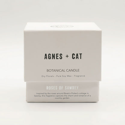 Box of Agnes + Cat botanical candle on a white background
