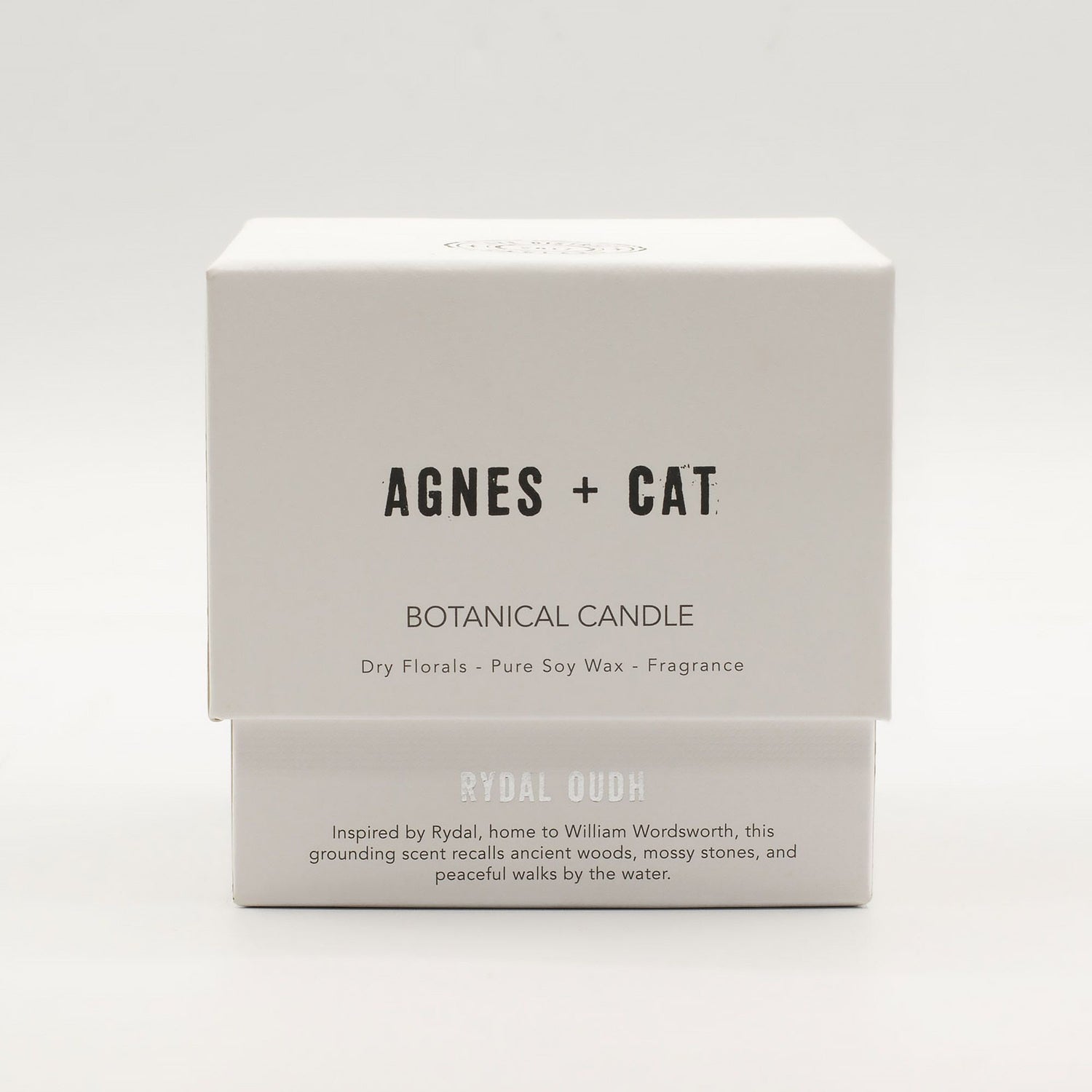 Box of Agnes + Cat botanical candle on a white background