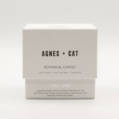 Box of Agnes + Cat botanical candle on a white background