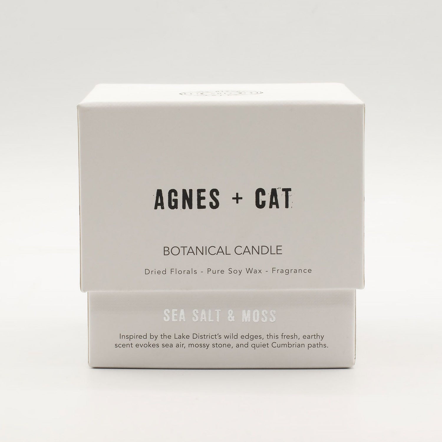 Agnes + Cat botanical candle packaging on a white background
