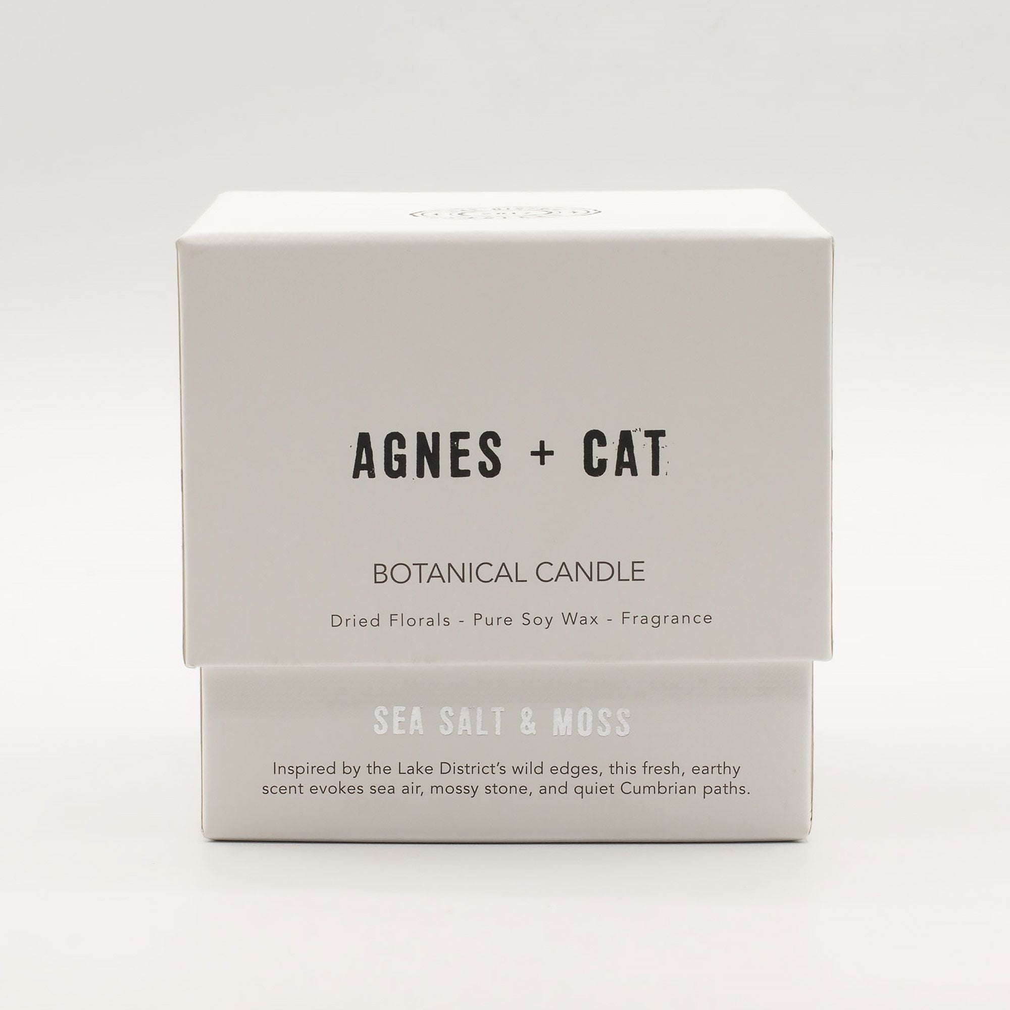 Agnes + Cat botanical candle packaging on a white background