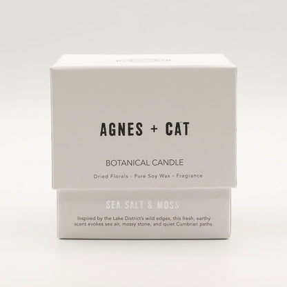 Agnes + Cat botanical candle packaging on a white background