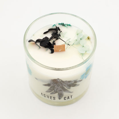 Candle in a glass jar with decorative elements and &