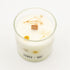 Candle in a glass jar with decorative elements on a white background, featuring the brand &