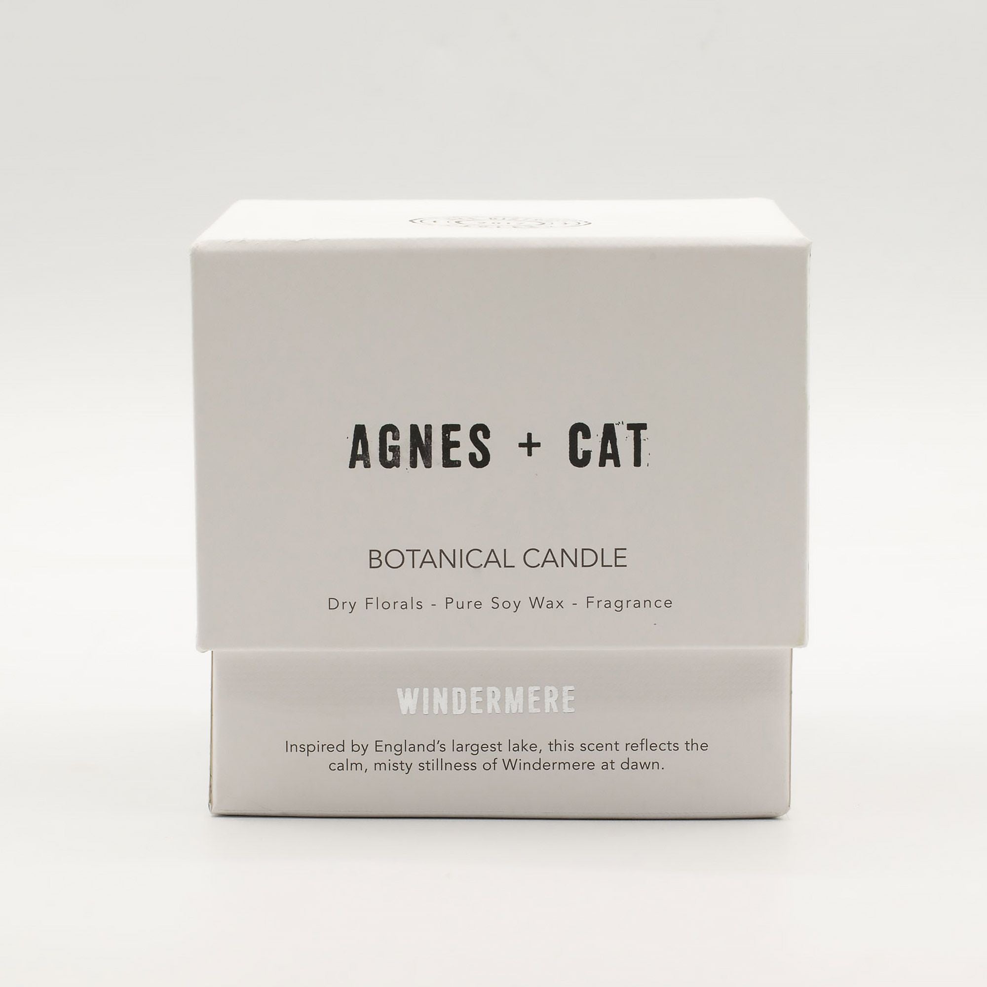 Box of Agnes + Cat botanical candle on a white background