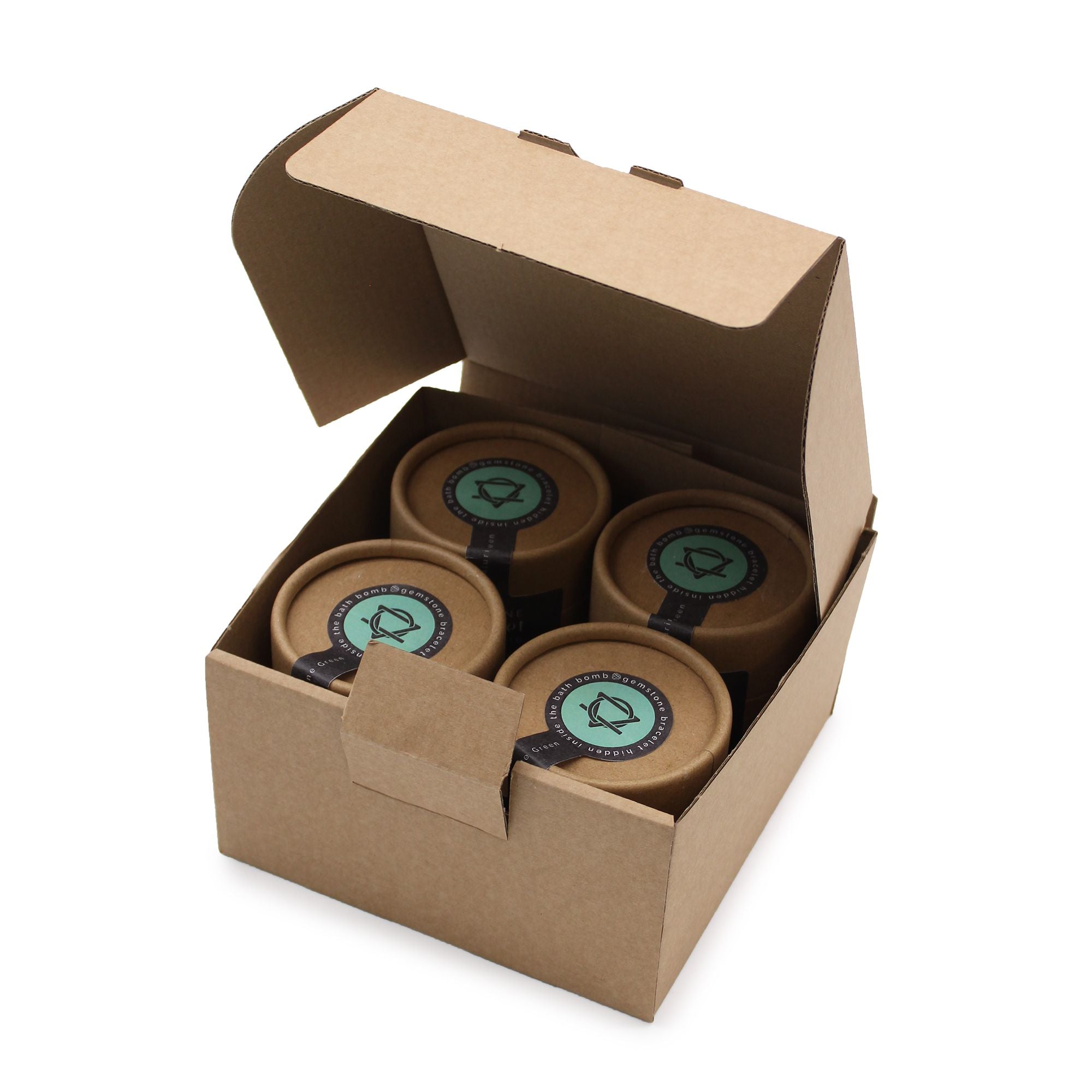Four brown jars with green labels in a cardboard box on a white background
