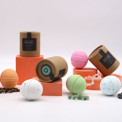 Colourful bath bombs with their packaging on a white background
