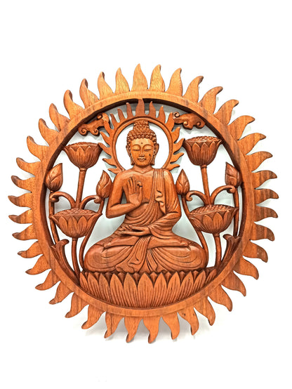 Wooden wall art with Buddha figure and lotus flowers on a white background