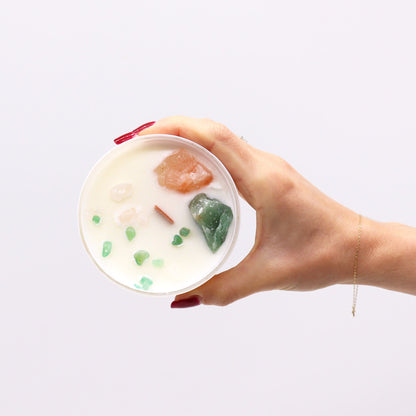 Hand holding a bowl of dessert with fruits against a white background