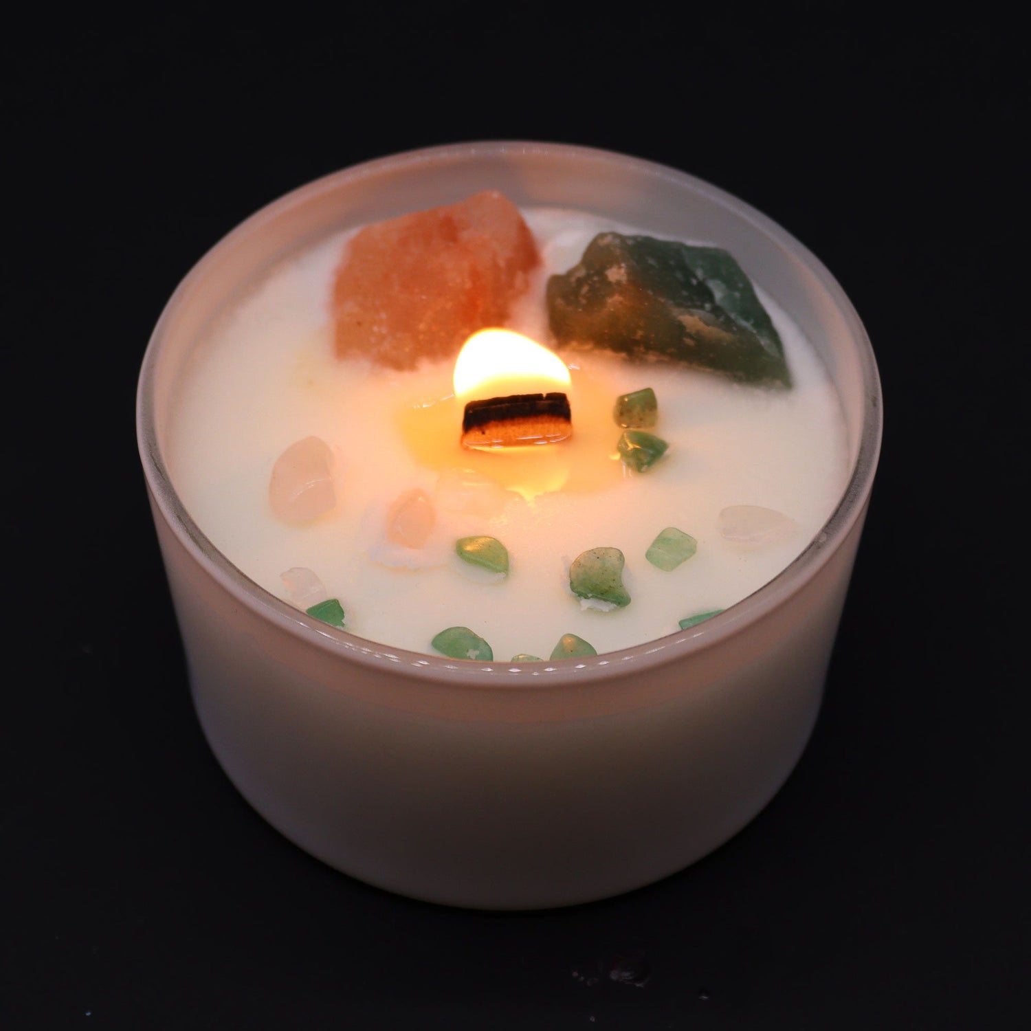 Candle with decorative elements on a black background