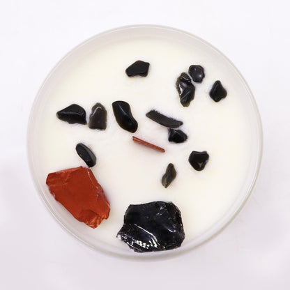 Round white candle with black and red elements on a white background