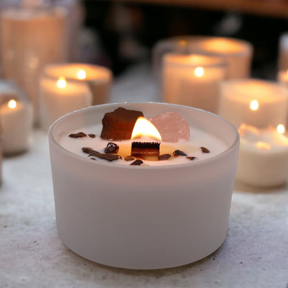 Candle on a table with other candles in the background