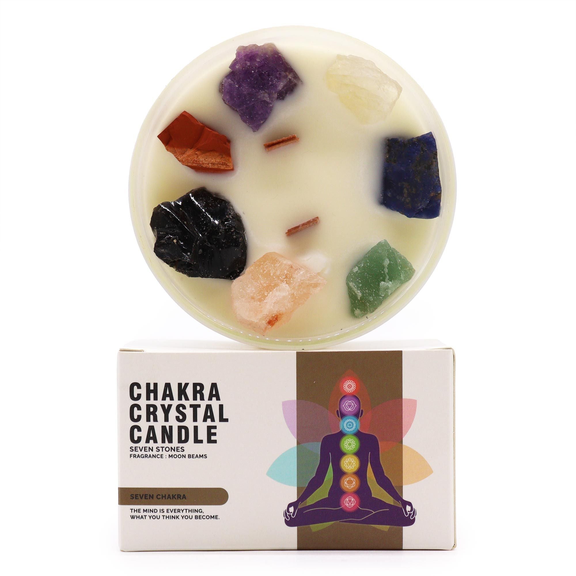 Chakra crystal candle with colorful stones on a white background