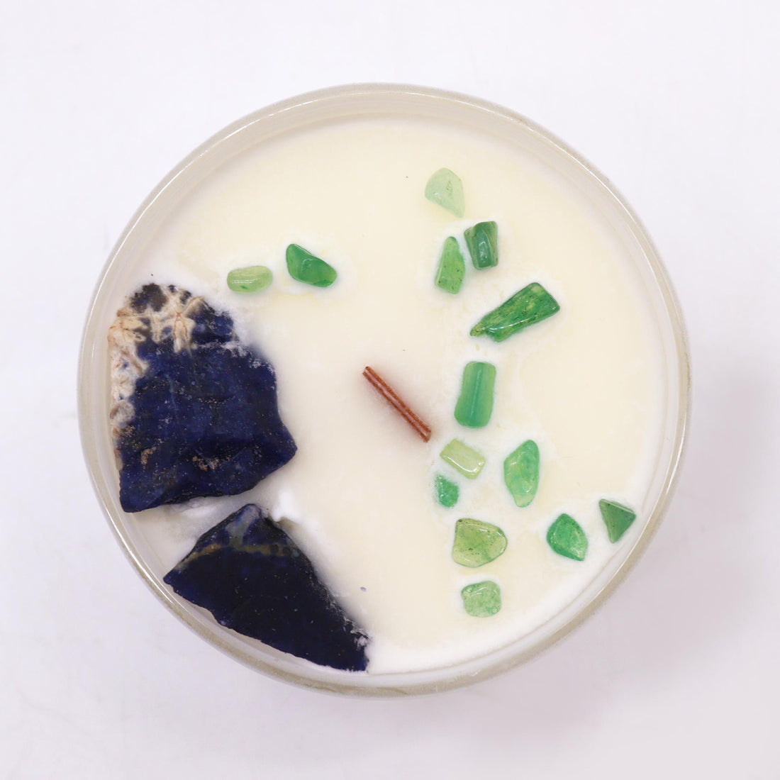 Candle with natural elements on a white background