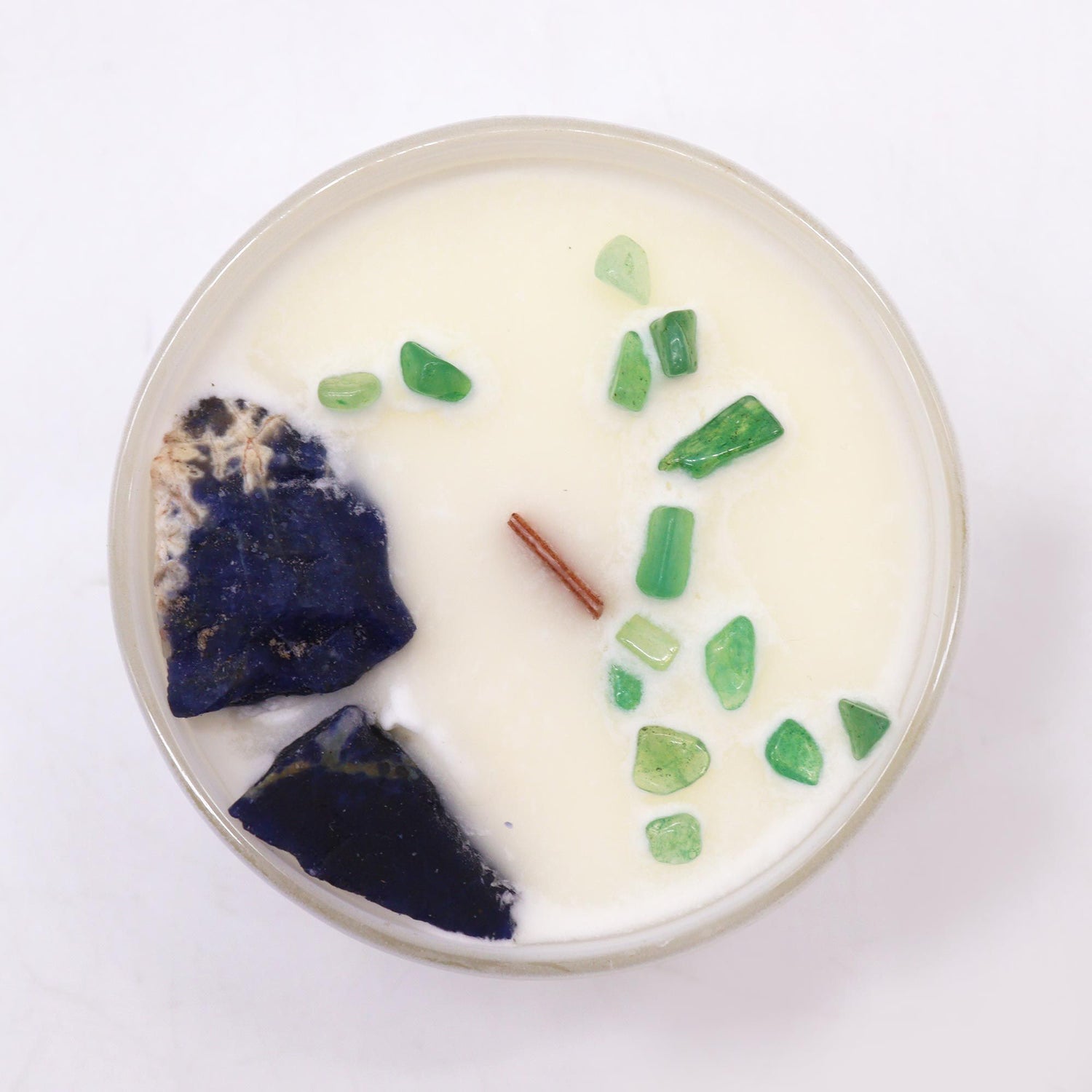 Candle with natural elements on a white background