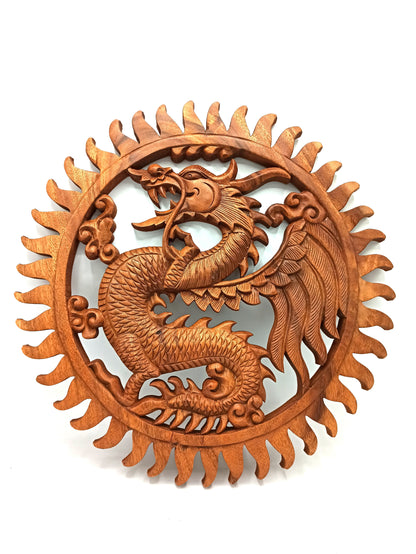 Wooden dragon wall art with sun design on a white background