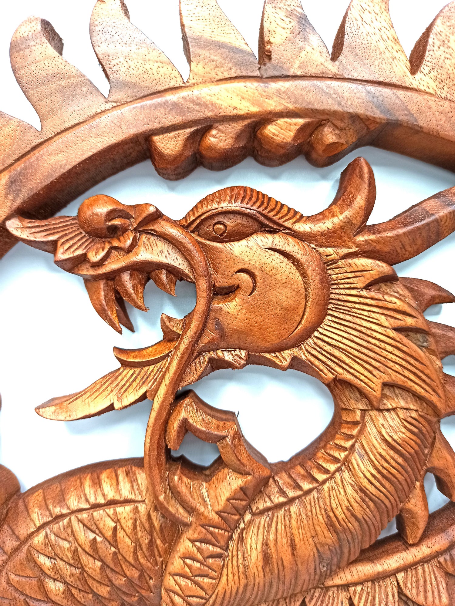 Wooden dragon sculpture on a white background