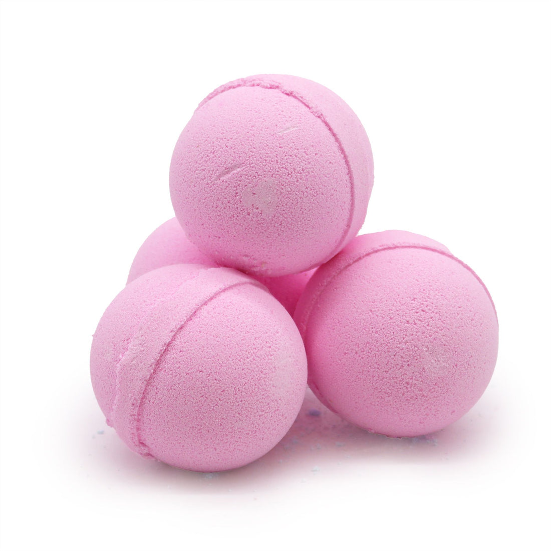 Three pink bath bombs on a white background