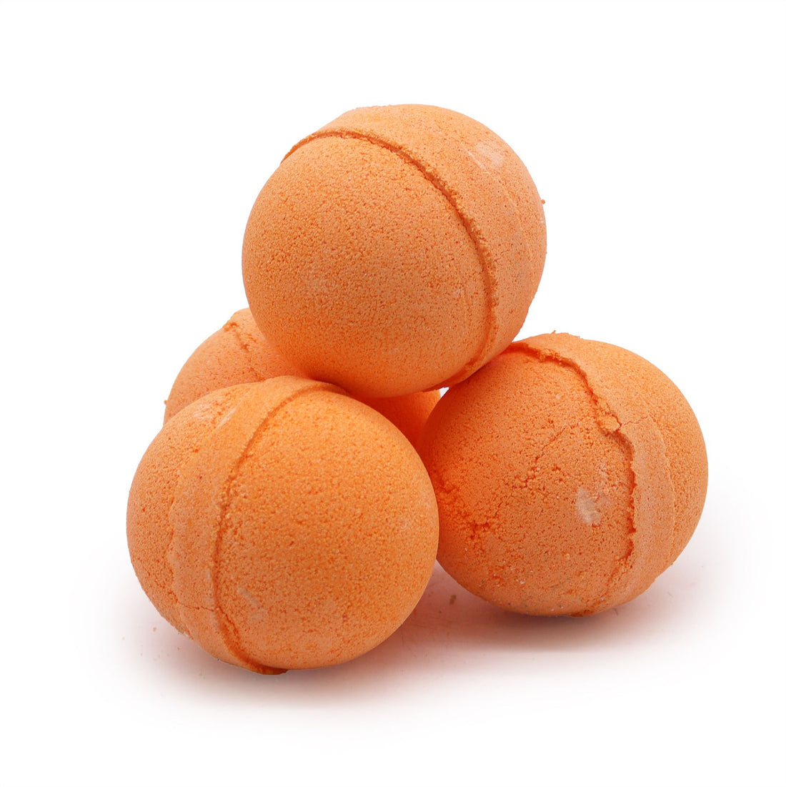 Four orange bath bombs stacked on a white background