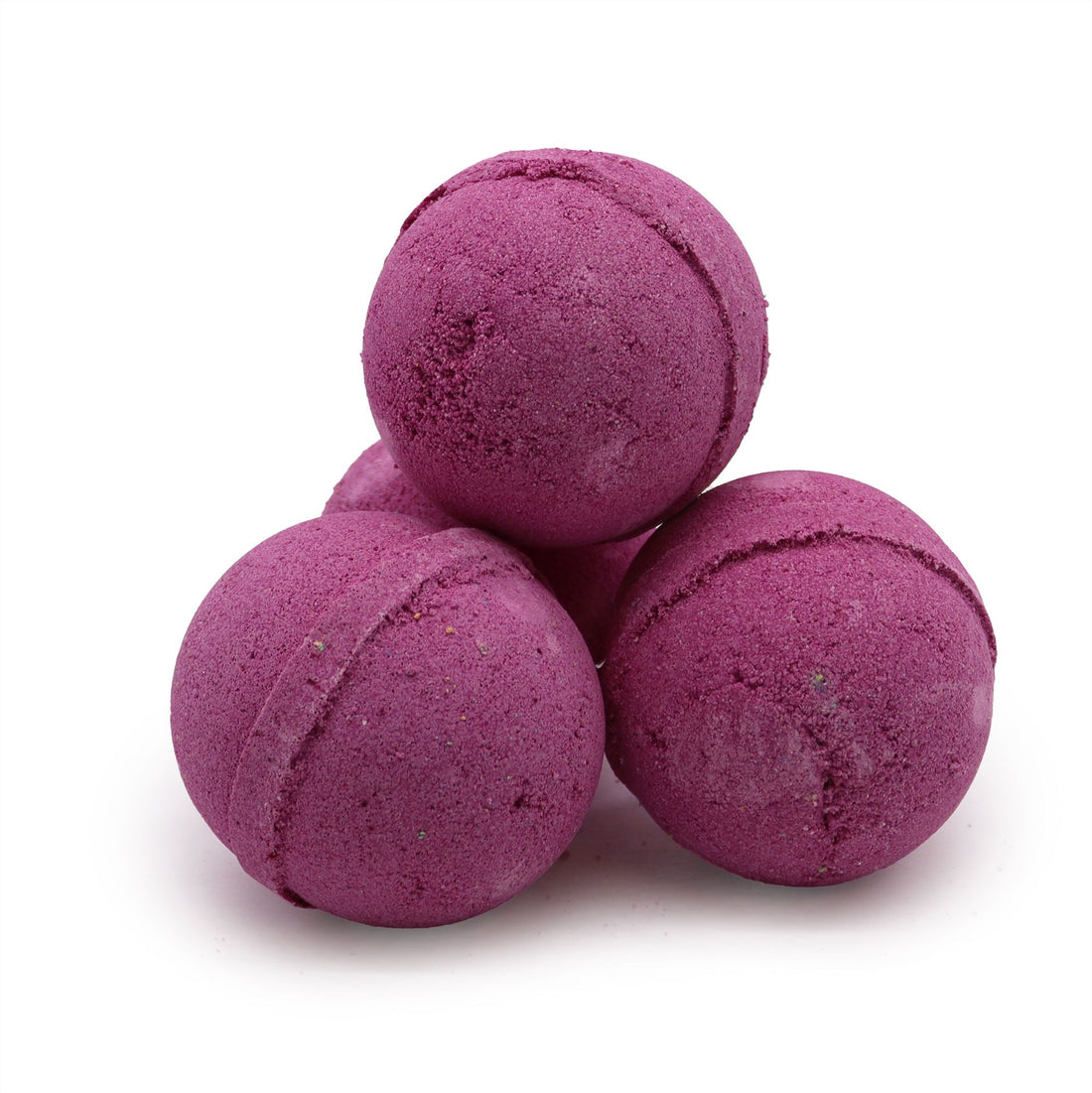 Purple bath bombs stacked on a white background