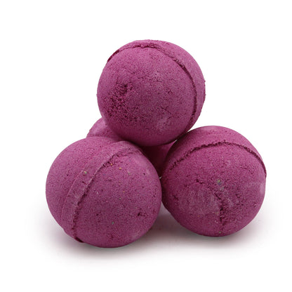 Purple bath bombs stacked on a white background