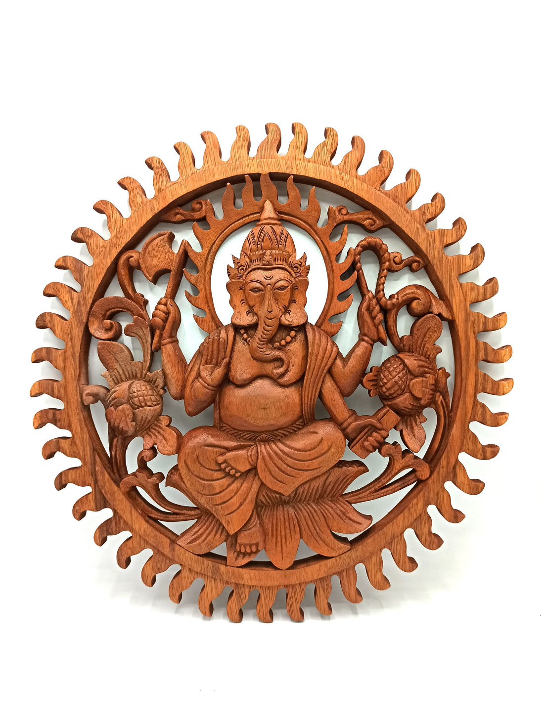 Wooden wall art depicting a seated figure with intricate carvings on a white background