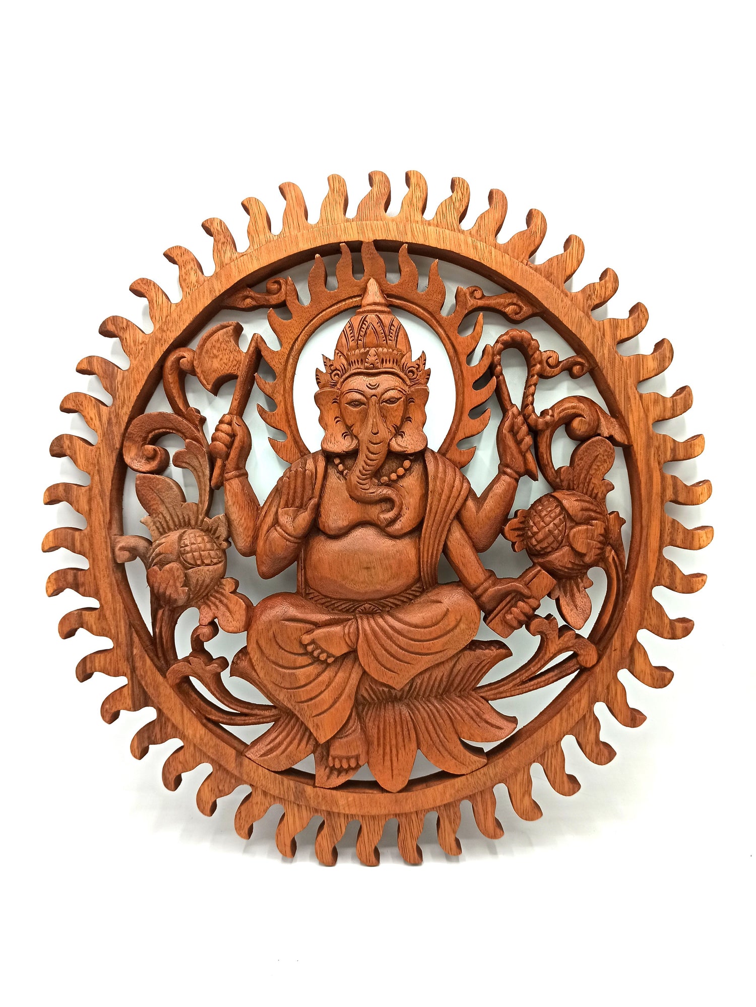 Wooden wall art depicting a seated figure with intricate carvings on a white background