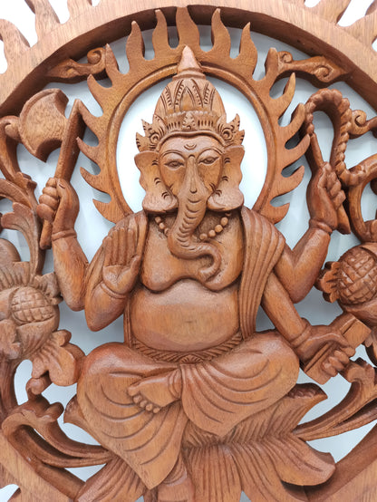 Wooden carving of a deity with intricate details on a white background