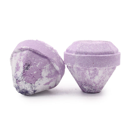 Two purple bath bombs with textured surfaces on a white background