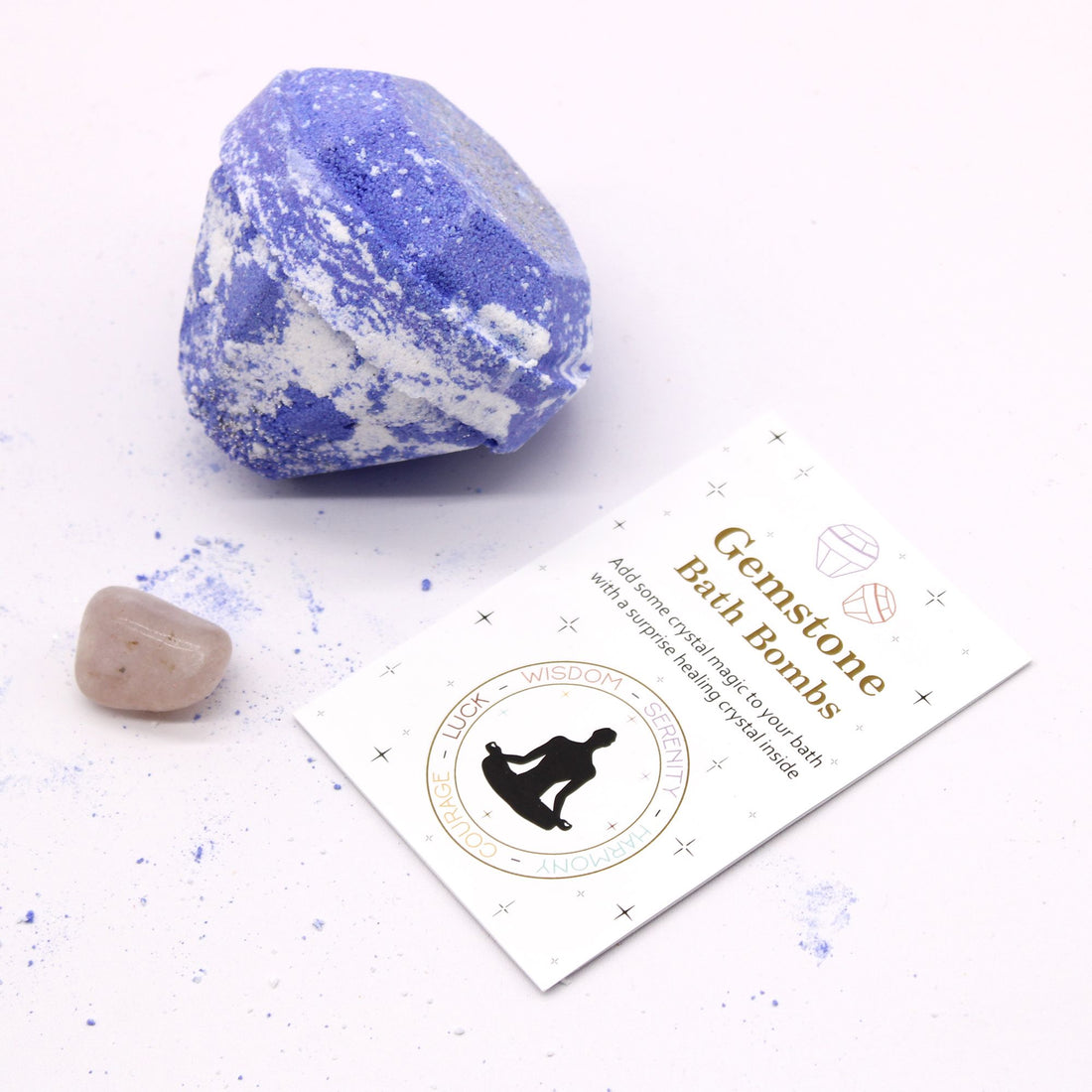 Blue and white gemstone bath bomb with a card on a white background