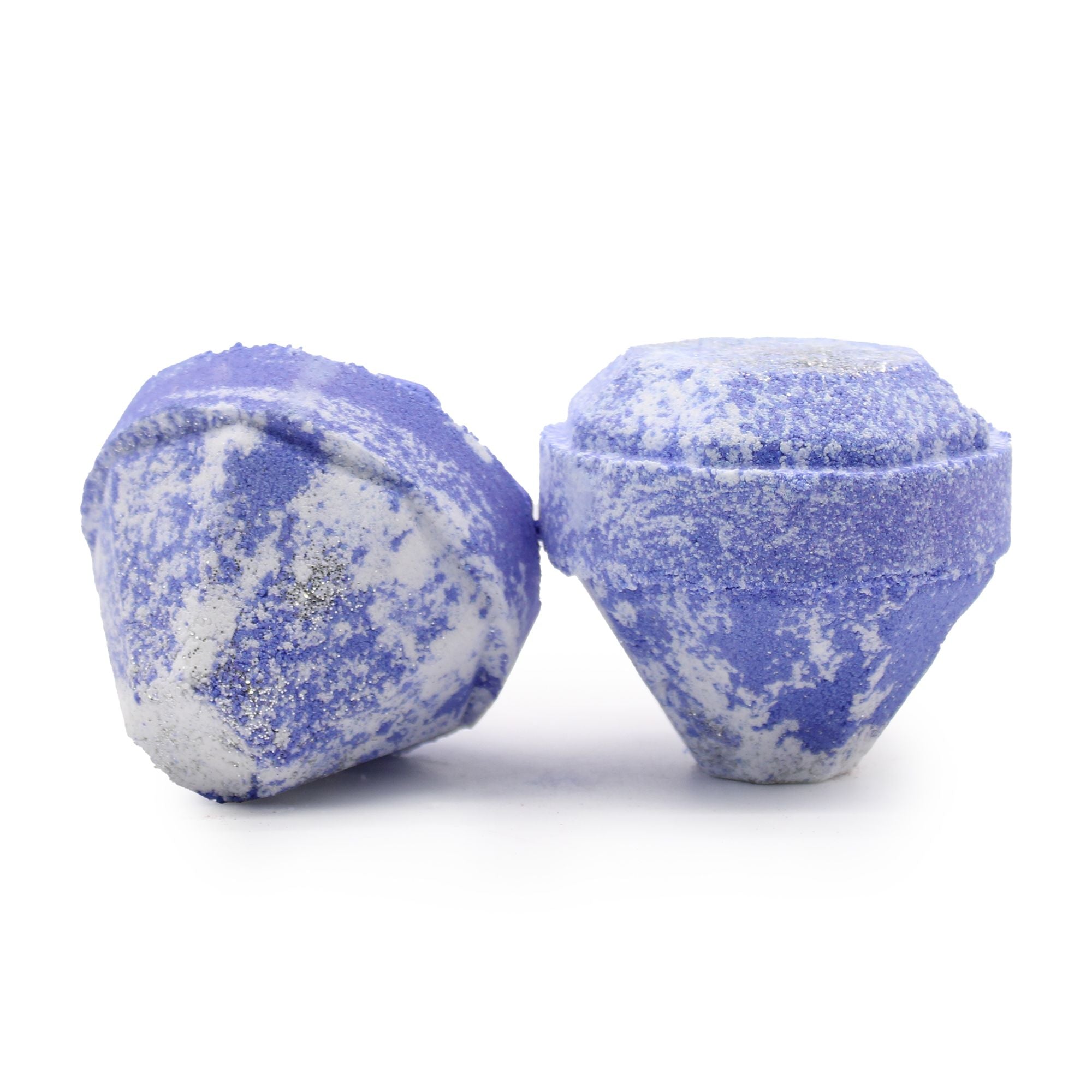 Two blue and white speckled bath bombs on a white background