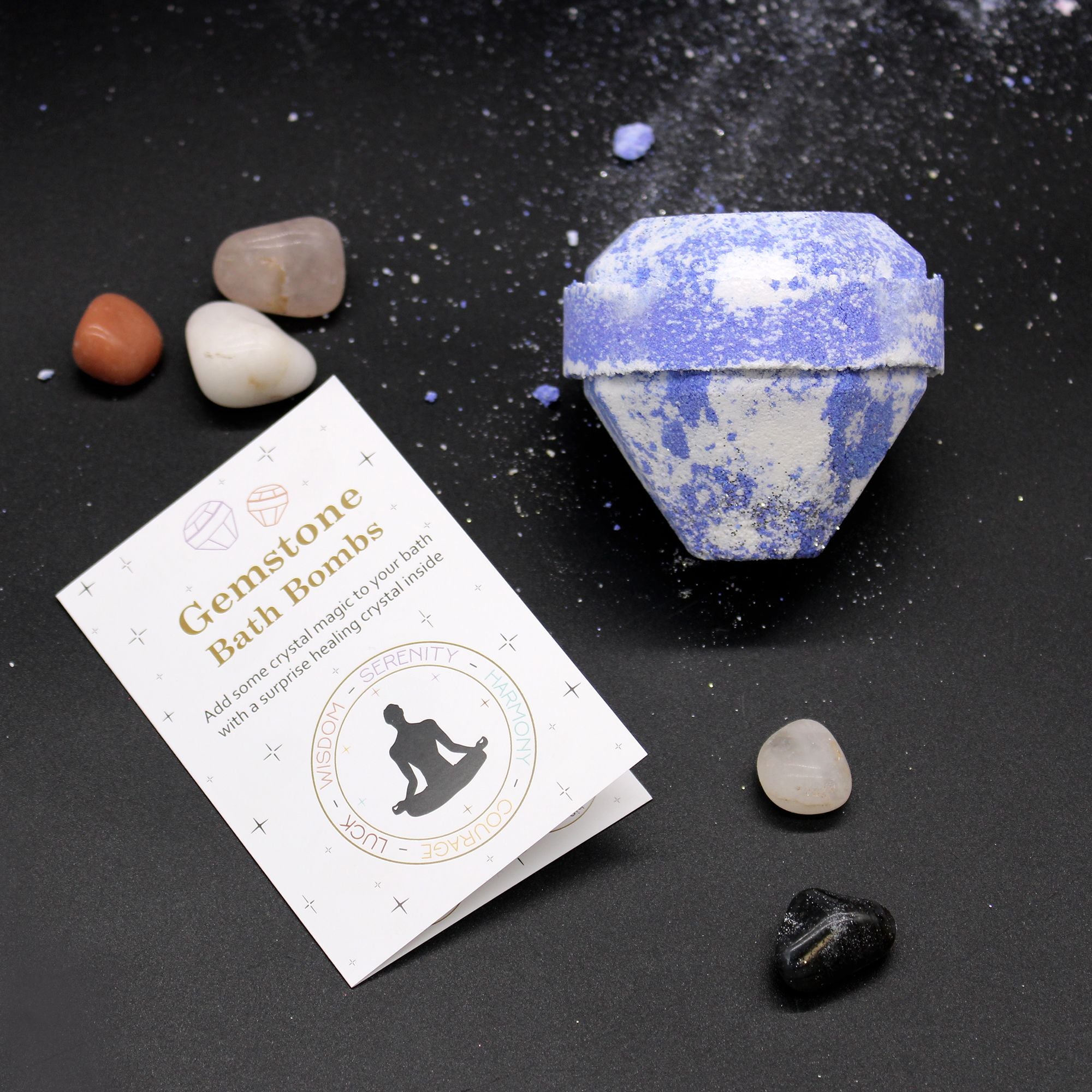 Gemstone bath bomb with packaging and crystals on a dark background