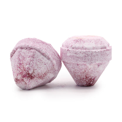 Two pink bath bombs with a textured surface on a white background