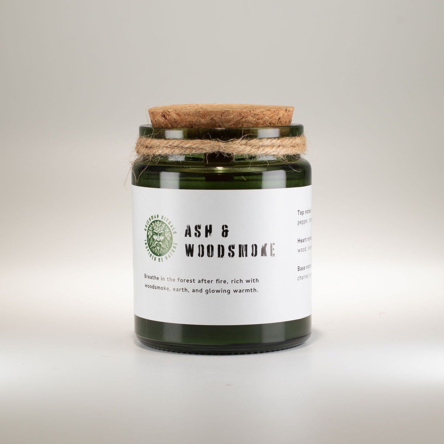 Candle jar with cork lid and label on a light gray background