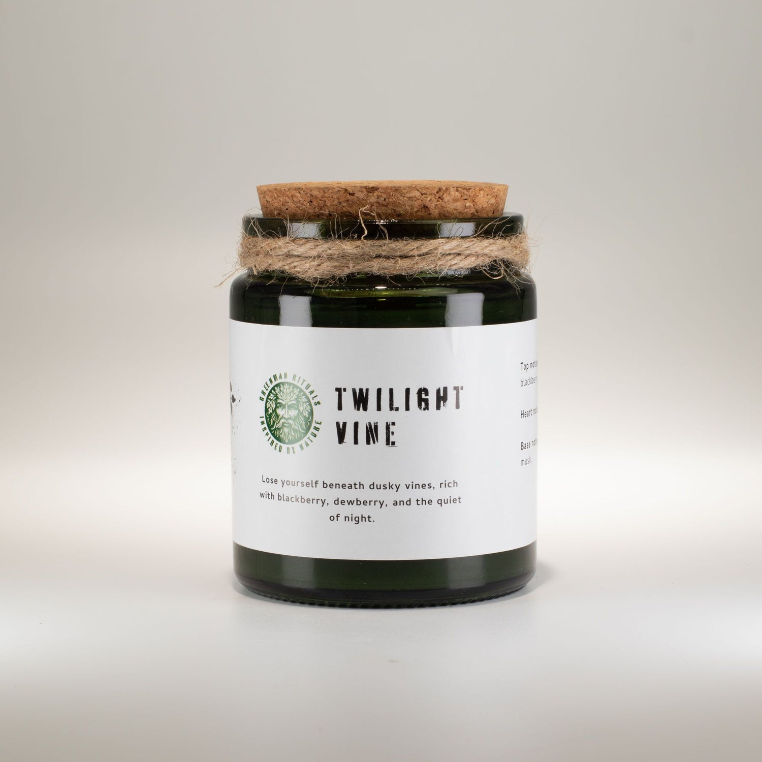 Candle in a glass jar with a cork lid on a light background