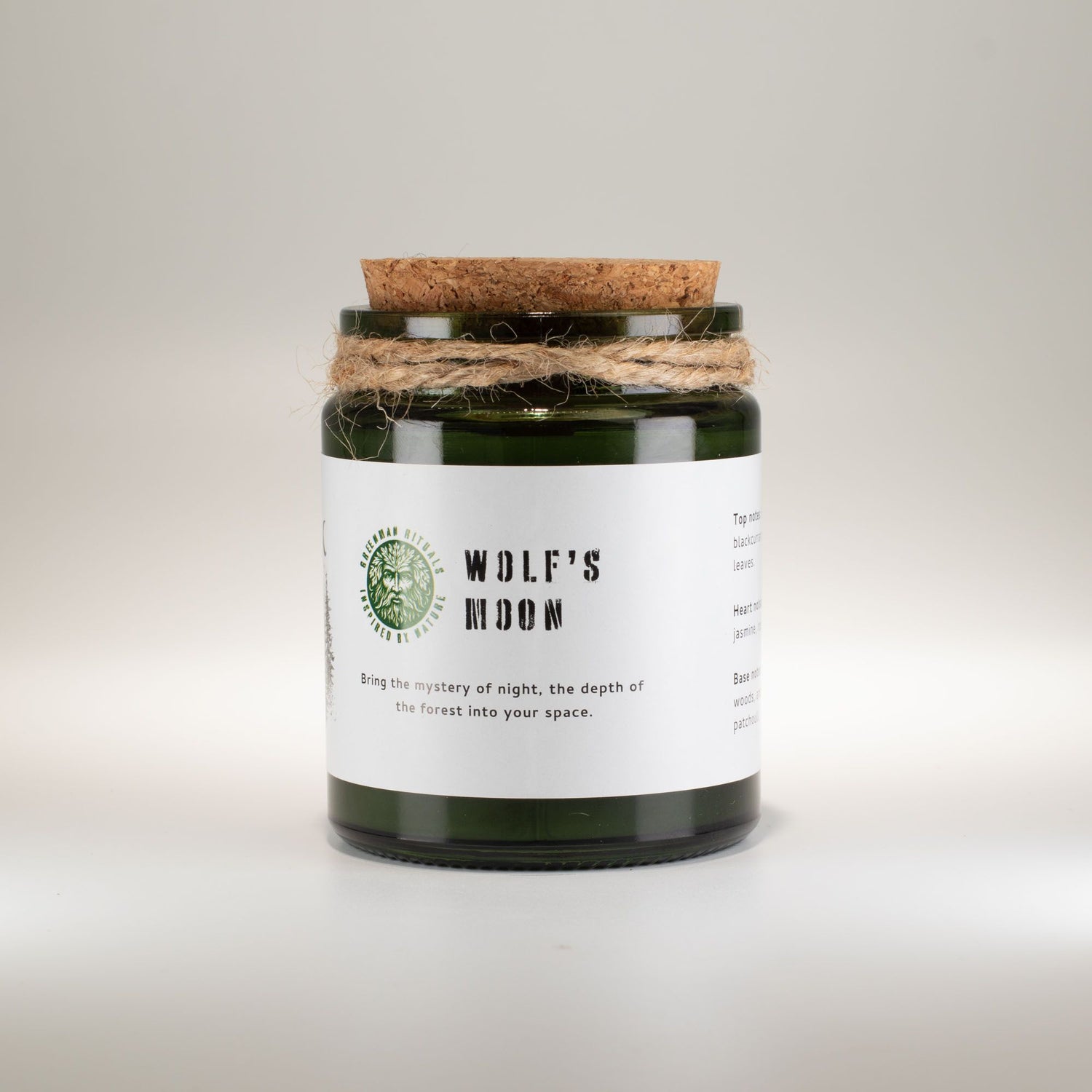 Candle with a cork lid and label on a light gray background