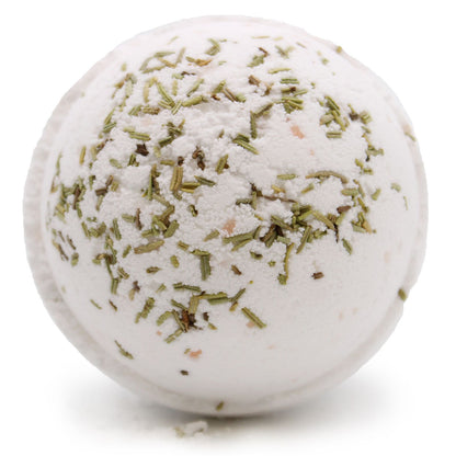 Bath bomb with green herbs on a white background