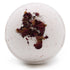 White bath bomb with dried flowers on a white background