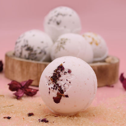 Bath bombs with natural ingredients on a pink background