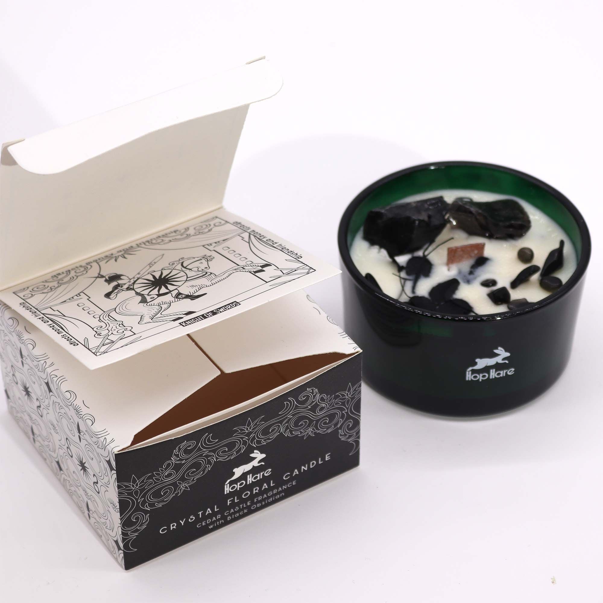 Crystal floral candle in a dark green holder with a decorative box on a white background